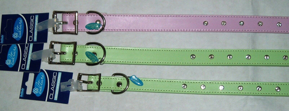 Rudducks Paw Culture Diamante Dog Collars in pink and green, shown laid flat with packaging tags attached, displaying buckle and D-ring hardware and diamante studs along the length.