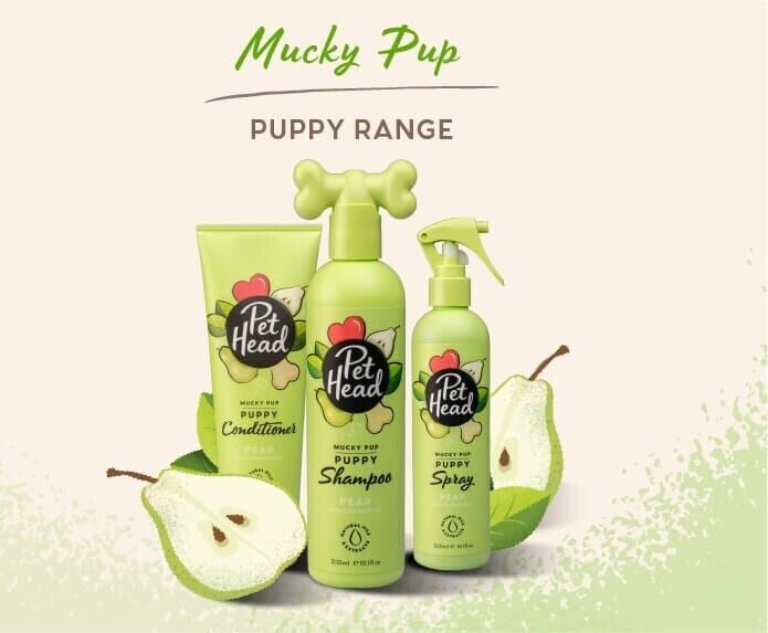 Pet Head Mucky Pup Puppy Range — shampoo, conditioner and spray bottles arranged together with pear fruit on a light background