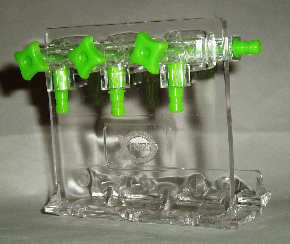 Unipet clear aquarium gang valve divider with green control knobs and outlet barbs, shown on its stand
