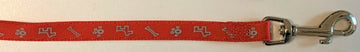 Close-up of a red 15mm nylon dog lead showing reflective paw and bone design with a silver snap hook clasp