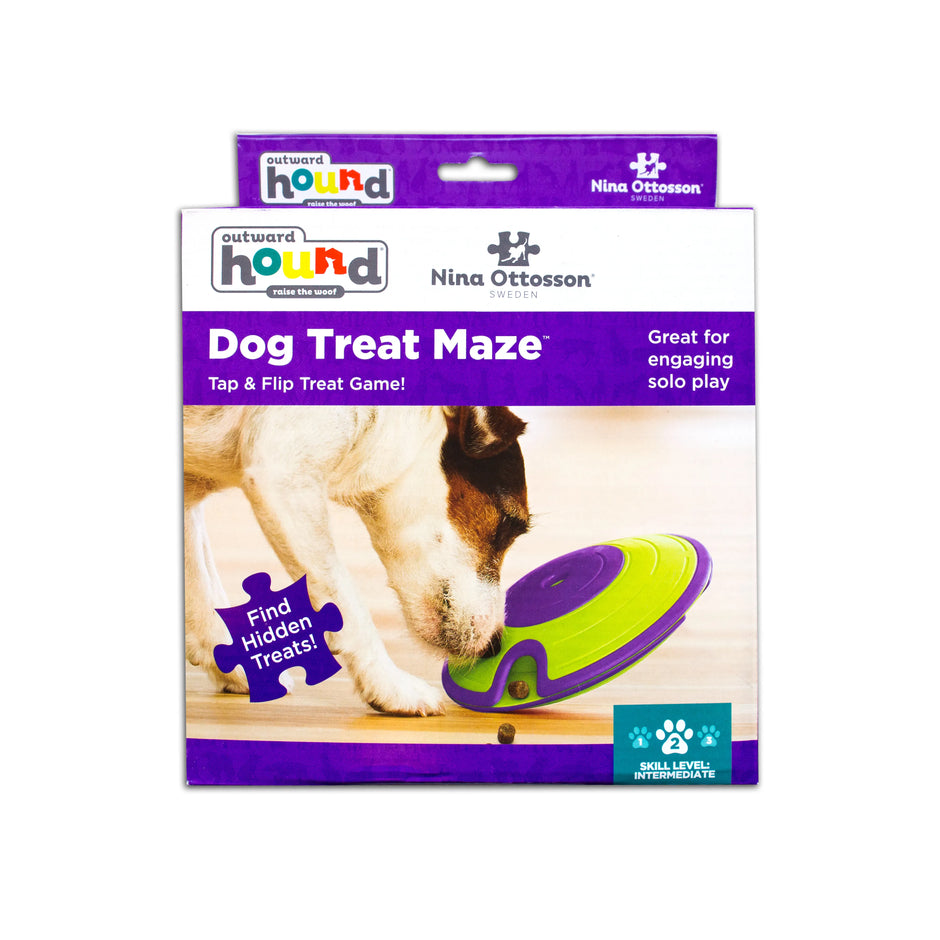 Outward Hound Nina Ottosson Dog Treat Maze retail box showing a dog nosing the green and purple disc puzzle, with skill level 2 intermediate indicated on the packaging