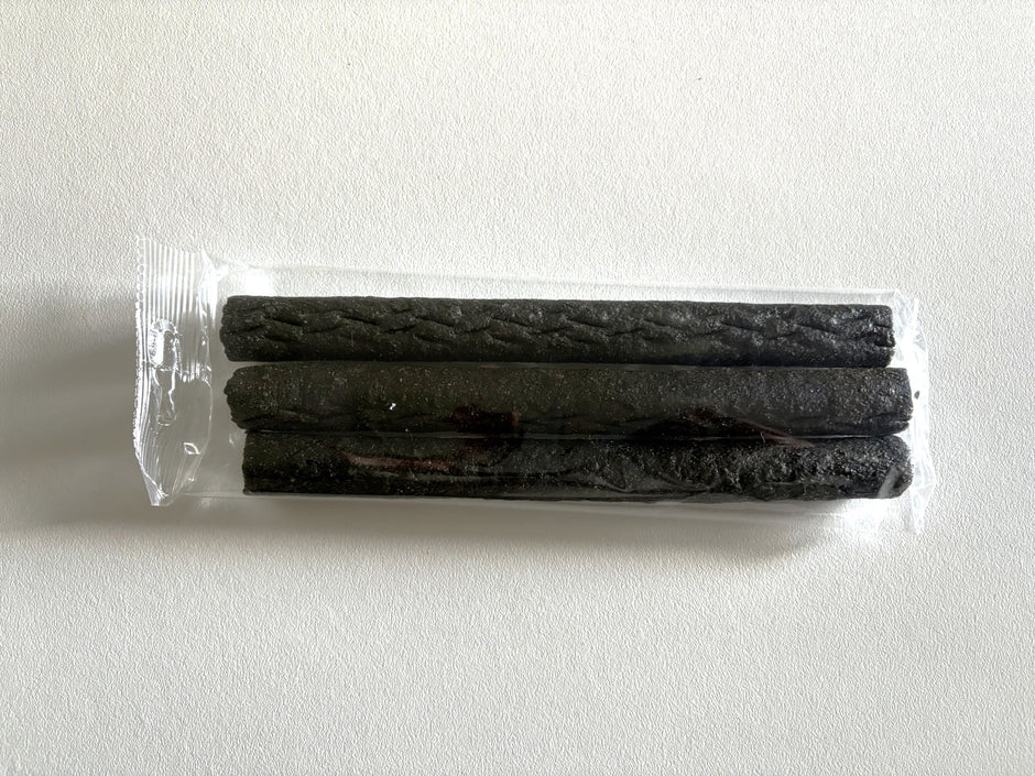 Three dark brown beef liver sticks sealed in a clear plastic pack, shown from above against a white background.
