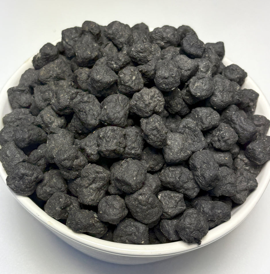A white bowl filled with GoPetPlace beef liver meat balls — small, dark, rough-textured dog treats