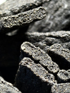 Close-up of the porous, dark-brown texture of a GoPetPlace beef liver strap dog treat