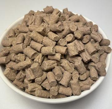 A white bowl filled with bite-sized GoPetPlace chicken nibbles dog treats