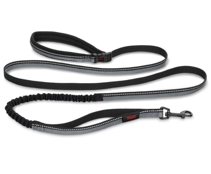 Halti Active Lead in black laid flat, showing the padded handle, bungee section, reflective strip, and trigger clip
