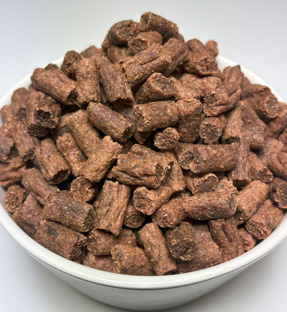A white bowl filled with bite-sized GoPetPlace kangaroo nibbles dog treats
