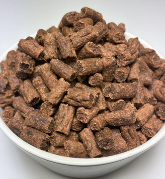 A white bowl filled with bite-sized GoPetPlace kangaroo nibbles dog treats