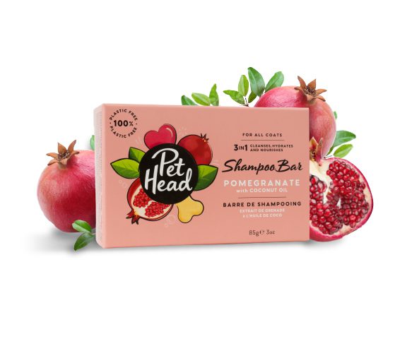 Pet Head 3-in-1 Pomegranate Shampoo Bar 85g box displayed with fresh pomegranates, showing 100% plastic-free and 3-in-1 claims on packaging