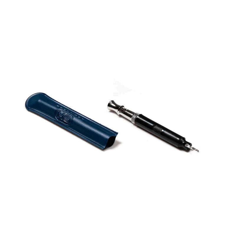 Herm Sprenger dog training whistle in nickel plated brass shown next to its blue HS-branded protective sleeve