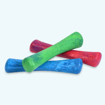 Three West Paw Drifty dog toys in blue, green, and red, showing the bone-shaped form, bulbous ends, and swirled ocean-inspired texture.