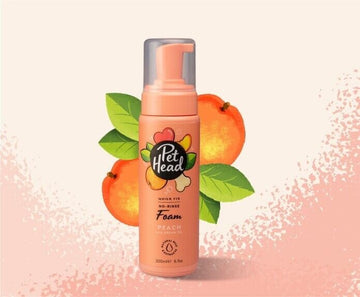 Pet Head Quick Fix No-Rinse Foam 200ml pump bottle in peach with illustrated peach fruit backdrop