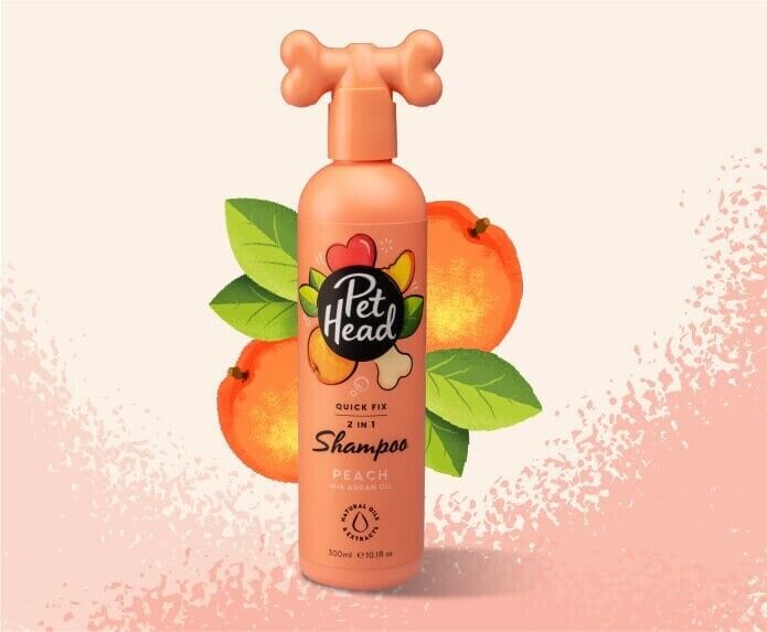 Pet Head Quick Fix 2-in-1 Dog Shampoo peach fragrance 300ml bottle with bone-shaped pump cap, styled against a peachy background with peach fruit and leaves