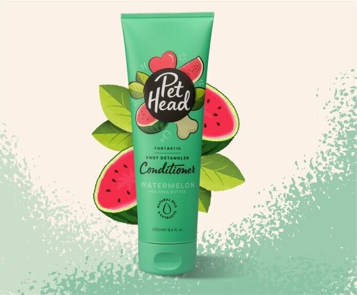 Pet Head Furtastic Knot Detangler Conditioner 250ml tube in mint green with watermelon scent branding, surrounded by watermelon slices and green leaves