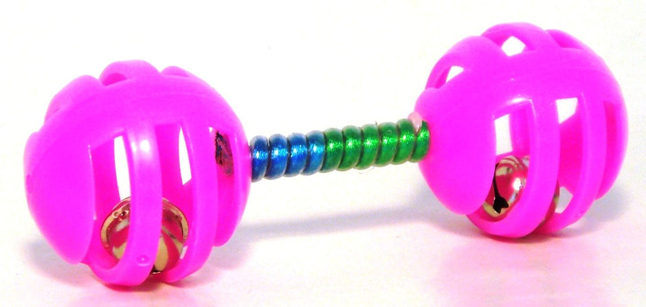 Pink lattice dumbbell cat toy with a coloured spiral handle and jingle bells inside each end ball, shown on a white background
