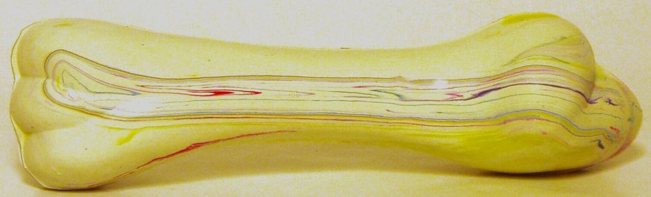 Rudducks Top Dog solid rubber bone in yellow with multicolour marbling, shown from the side — small size