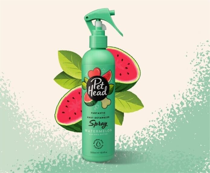 Pet Head Furtastic Knot Detangler Spray 300ml bottle in green with watermelon scent, surrounded by watermelon slices and leaves