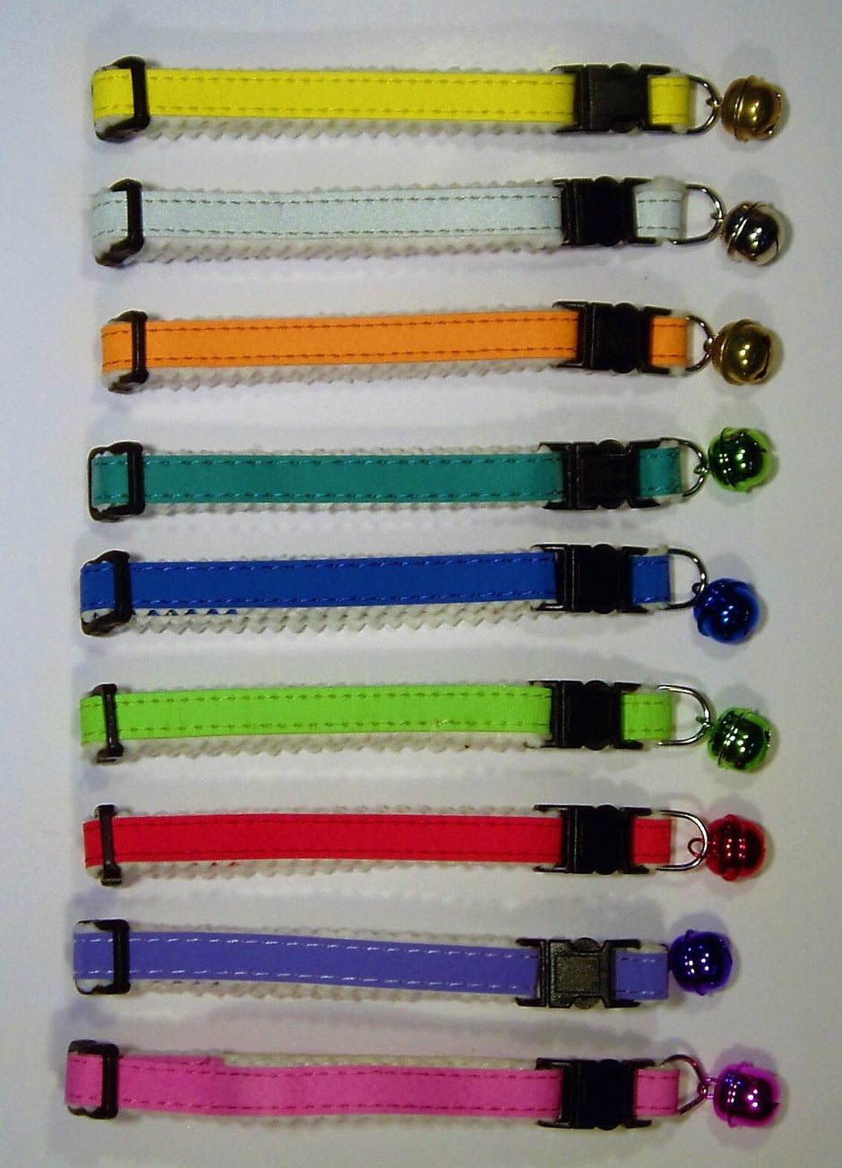 Nine GoPetPlace adjustable felt-lined cat collars laid flat in a row, showing a range of colours including yellow, orange, teal, blue, green, red, purple and pink, each with a matching coloured bell and quick-release buckle.
