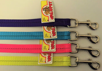 Four nylon dog leads laid flat showing all available colours — purple, blue, pink, and fluro yellow — each with a silver bolt snap clasp and a Valupet hang tag.