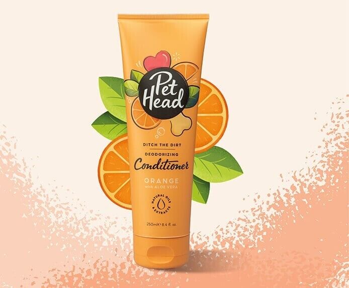 Pet Head Ditch the Dirt Deodorising Dog Conditioner 250ml orange tube on a light background with orange fruit illustration