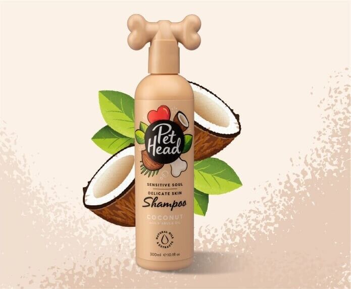 Pet Head Sensitive Soul Delicate Skin Dog Shampoo 300ml bottle with bone-shaped pump cap, shown in front of fresh coconut halves and green leaves