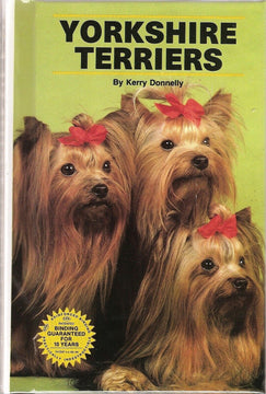 Front cover of Yorkshire Terriers by Kerry Donnelly, showing three groomed Yorkies with red bows on a green background, hardcover edition with 10-year binding guarantee badge