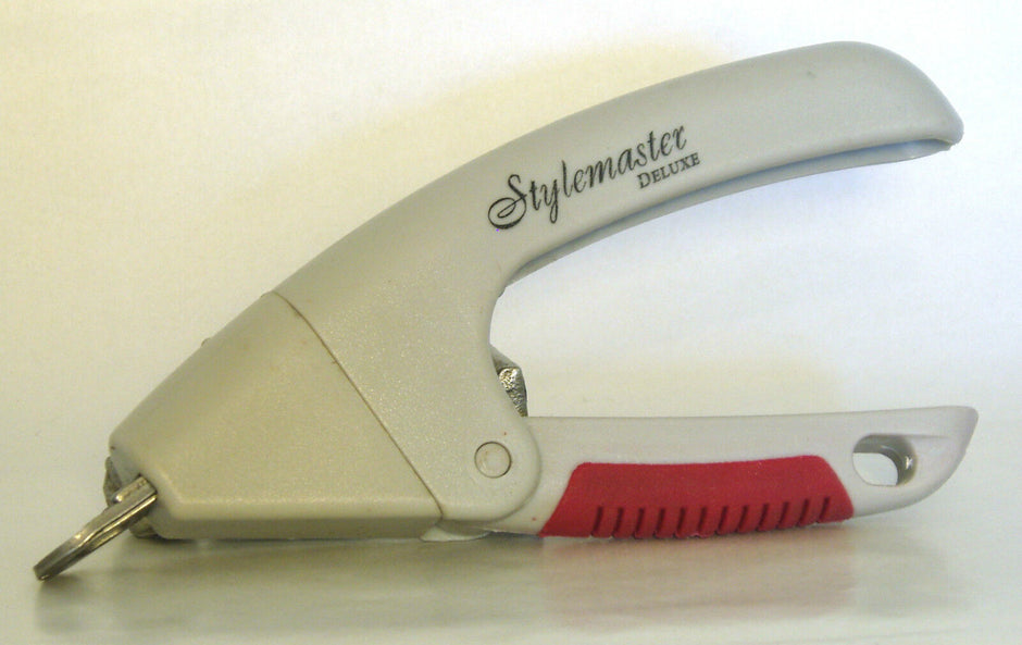 Kramar Stylemaster Deluxe guillotine pet nail clippers in silver with a red textured grip and circular nail groove, shown from the side.