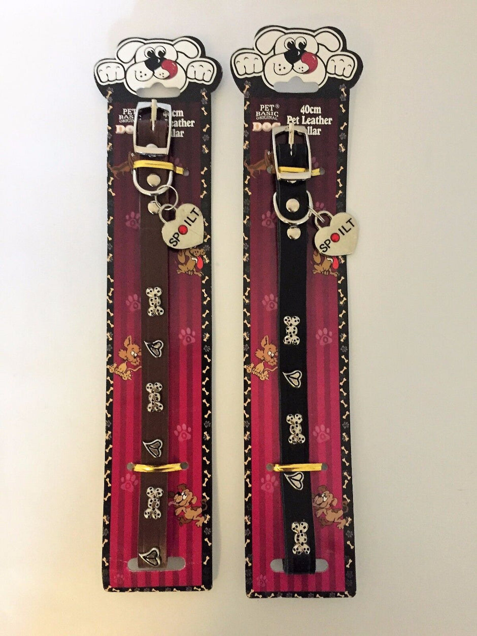 Pet Basic studded puppy dog collar in brown and black, each with bone and heart studs and a heart-shaped Spoilt charm tag, shown in packaging.