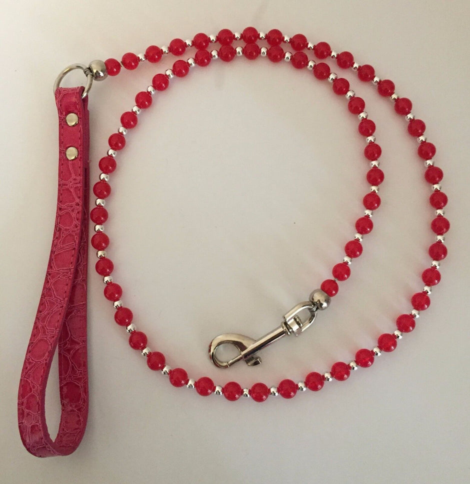 GoPetPlace 120cm beaded dog lead in red, showing red beads alternating with silver beads on wire, a silver snap clip at one end, and a red textured wrist-loop handle at the other.