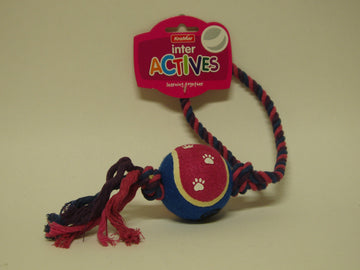 KraMar Inter Actives Sling Ball dog toy — blue and pink tennis-style ball with paw print design threaded onto a twisted rope with a loop handle, shown on retail card packaging.